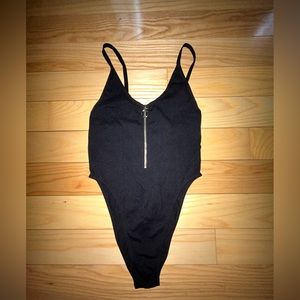 Black bodysuit with functioning zipper.